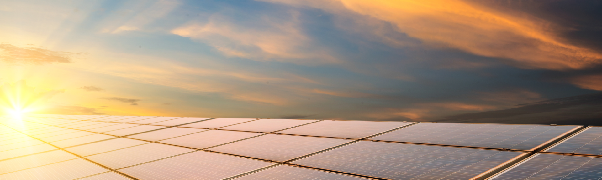 Workers in safety gear installing a solar panel outdoors.
